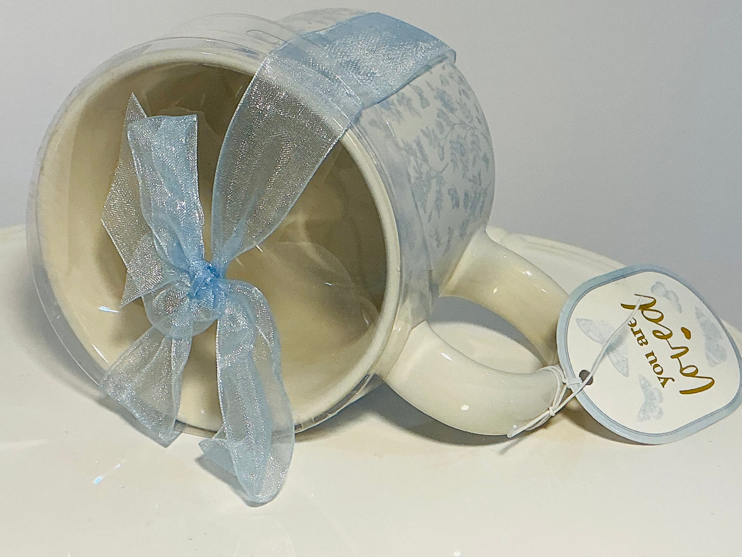 Sunday Morning Ceramics, flowers patterns large mug w/blue ribbon & tag that reads “you are loved”