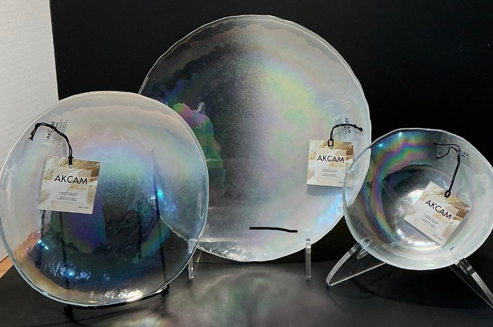 Akcam Iridescent Glass Set of 3 includes a  10” 8” plates and a 6” bowl, which are handmade in Turkey known with their shimmering opal-like finish that changes color with light.