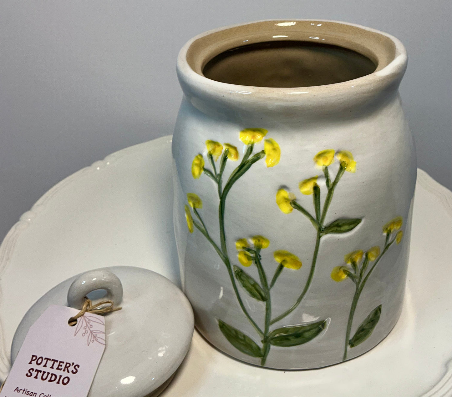 Potter’s Studio artisan collection stoneware storage jar, featuring hand-painted yellow flowers 7”