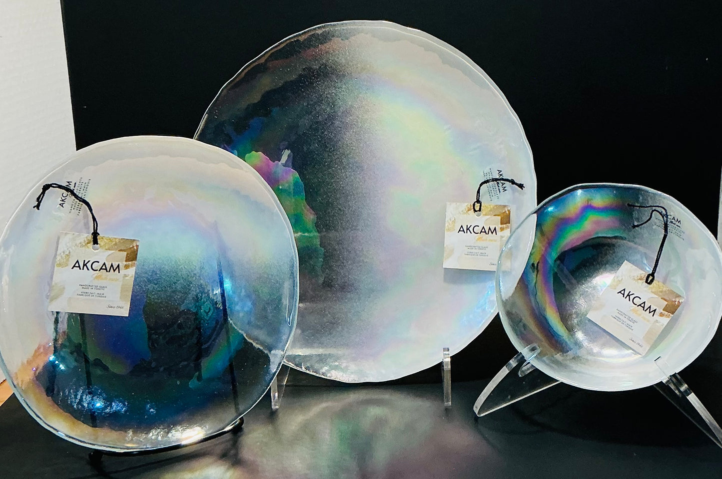 Akcam Iridescent Glass Set of 3 includes a  10” 8” plates and a 6” bowl, which are handmade in Turkey known with their shimmering opal-like finish that changes color with light.