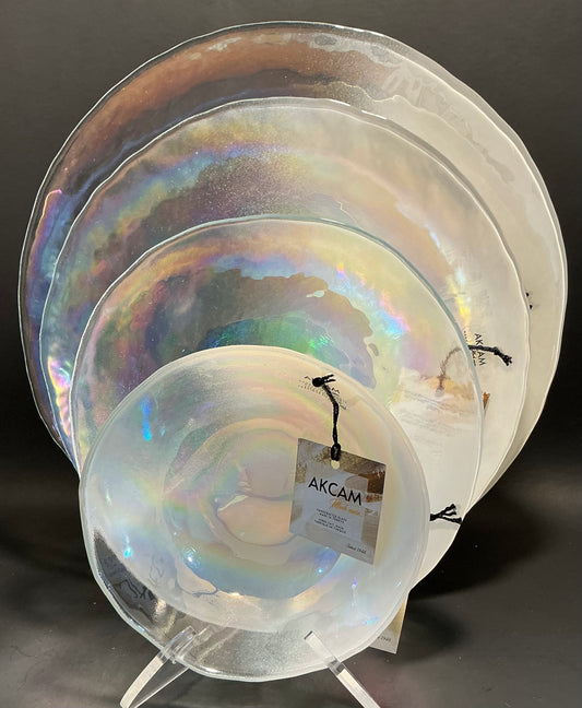 Akcam Iridescent Glass Set of 4 includes a  12” 10” 8” plates and a 6” bowl, which are handmade in Turkey known with their shimmering opal-like finish that changes color with light.