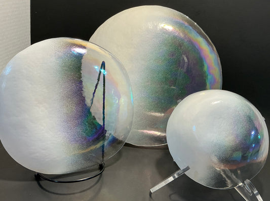 Akcam Iridescent Glass Set of 3 includes a  10” 8” plates and a 6” bowl, which are handmade in Turkey known with their shimmering opal-like finish that changes color with light.