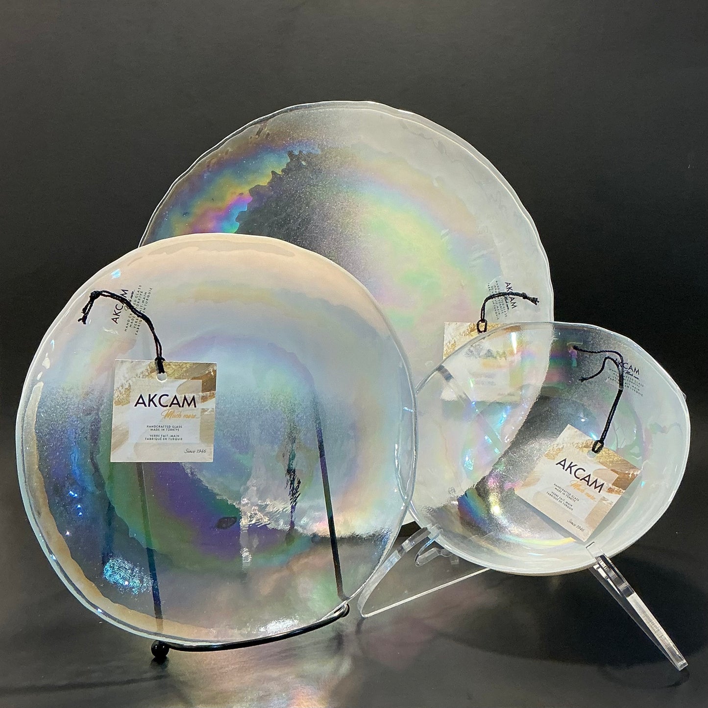 Akcam Iridescent Glass Set of 3 includes a  10” 8” plates and a 6” bowl, which are handmade in Turkey known with their shimmering opal-like finish that changes color with light.