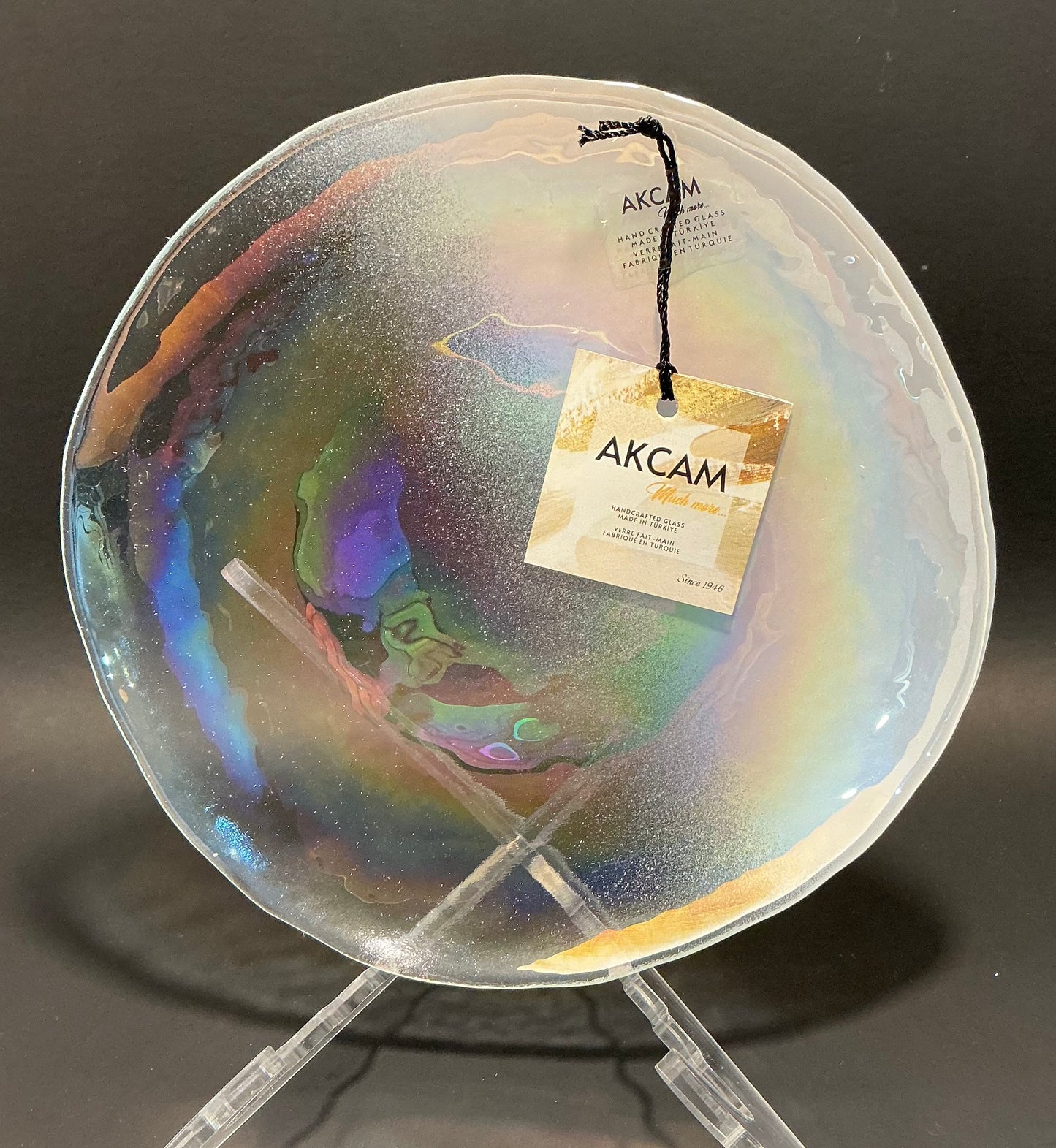 Akcam Iridescent Glass Set of 4 includes a  12” 10” 8” plates and a 6” bowl, which are handmade in Turkey known with their shimmering opal-like finish that changes color with light.