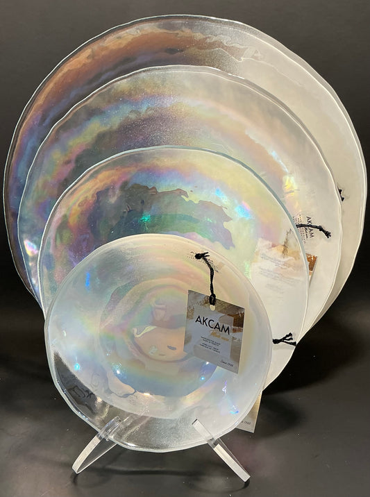 Akcam Iridescent Glass Set of 4 includes a  12” 10” 8” plates and a 6” bowl, which are handmade in Turkey known with their shimmering opal-like finish that changes color with light.