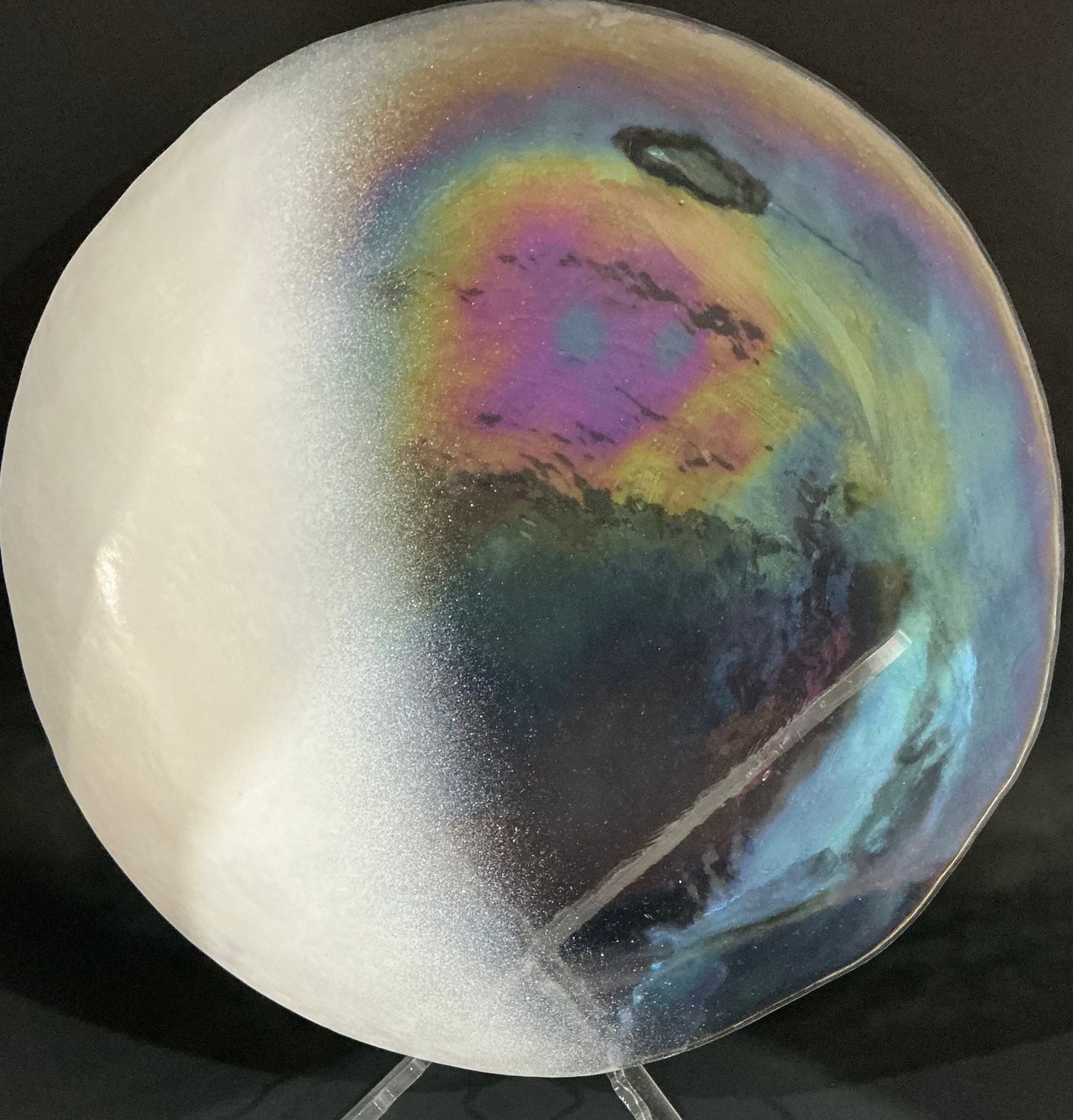 Akcam Iridescent Glass Set of 4 includes a  12” 10” 8” plates and a 6” bowl, which are handmade in Turkey known with their shimmering opal-like finish that changes color with light.