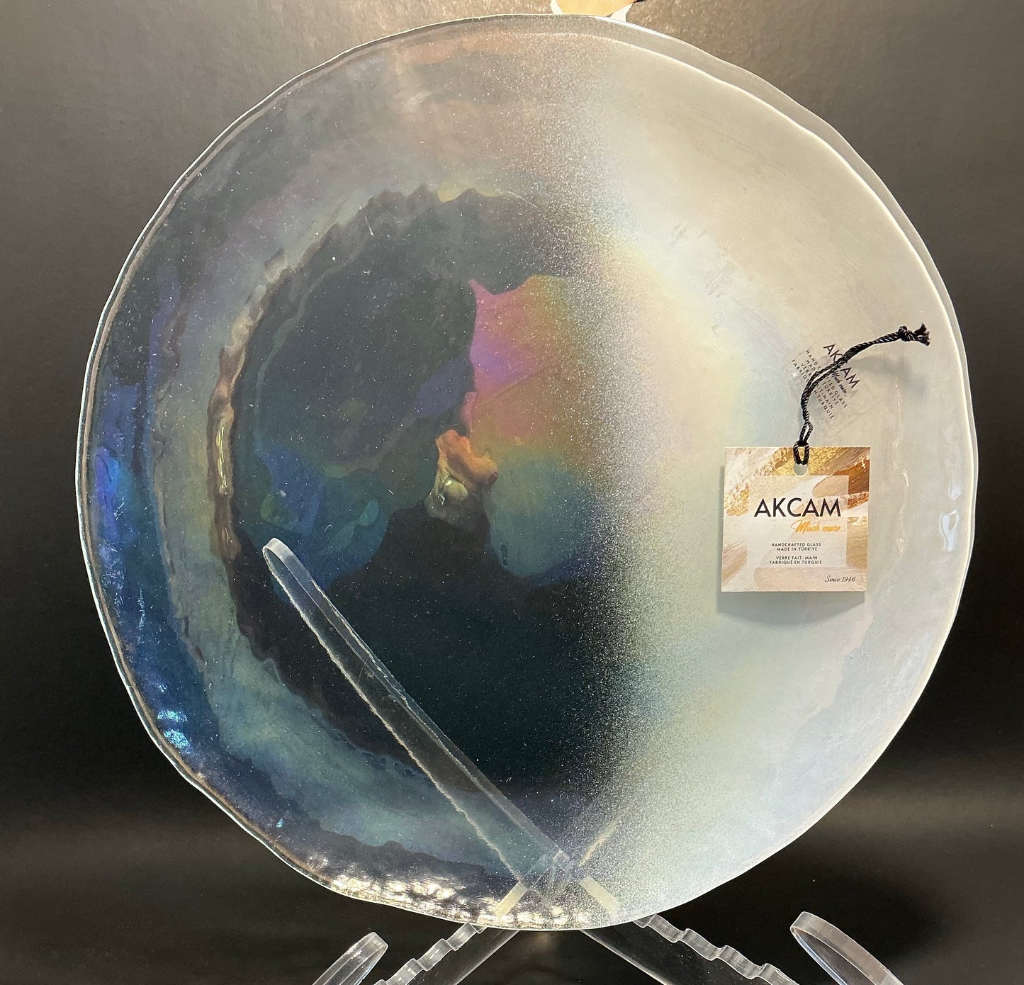 Akcam Iridescent Glass Set of 4 includes a  12” 10” 8” plates and a 6” bowl, which are handmade in Turkey known with their shimmering opal-like finish that changes color with light.