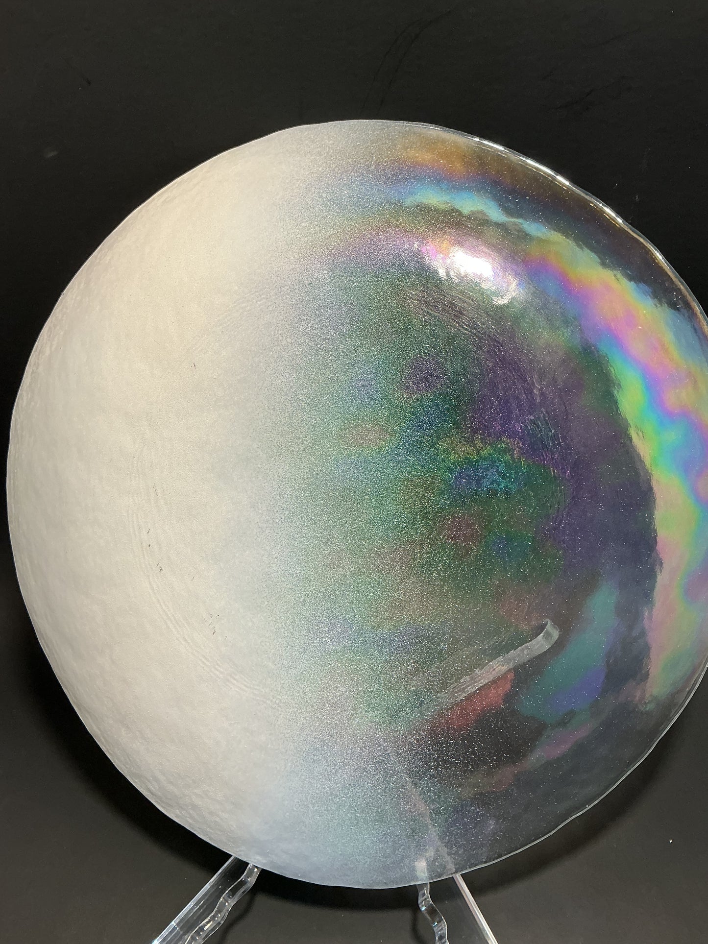 Akcam Iridescent Dinner plate 10” which is handmade in Turkey with their shimmering opal-like finish that changes color with light.